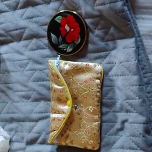 1950s compact mirror by Stratton, red Camelia enamel image. With yellow zip bag